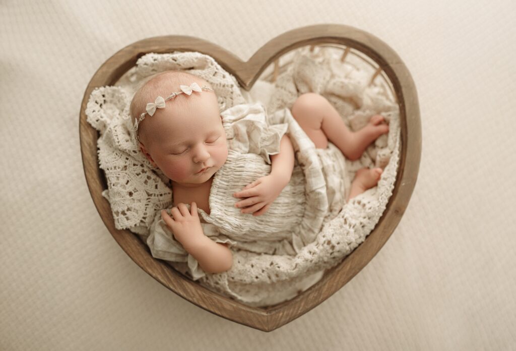Cozy newborn photography studio with neutral props, blankets, and baby wraps