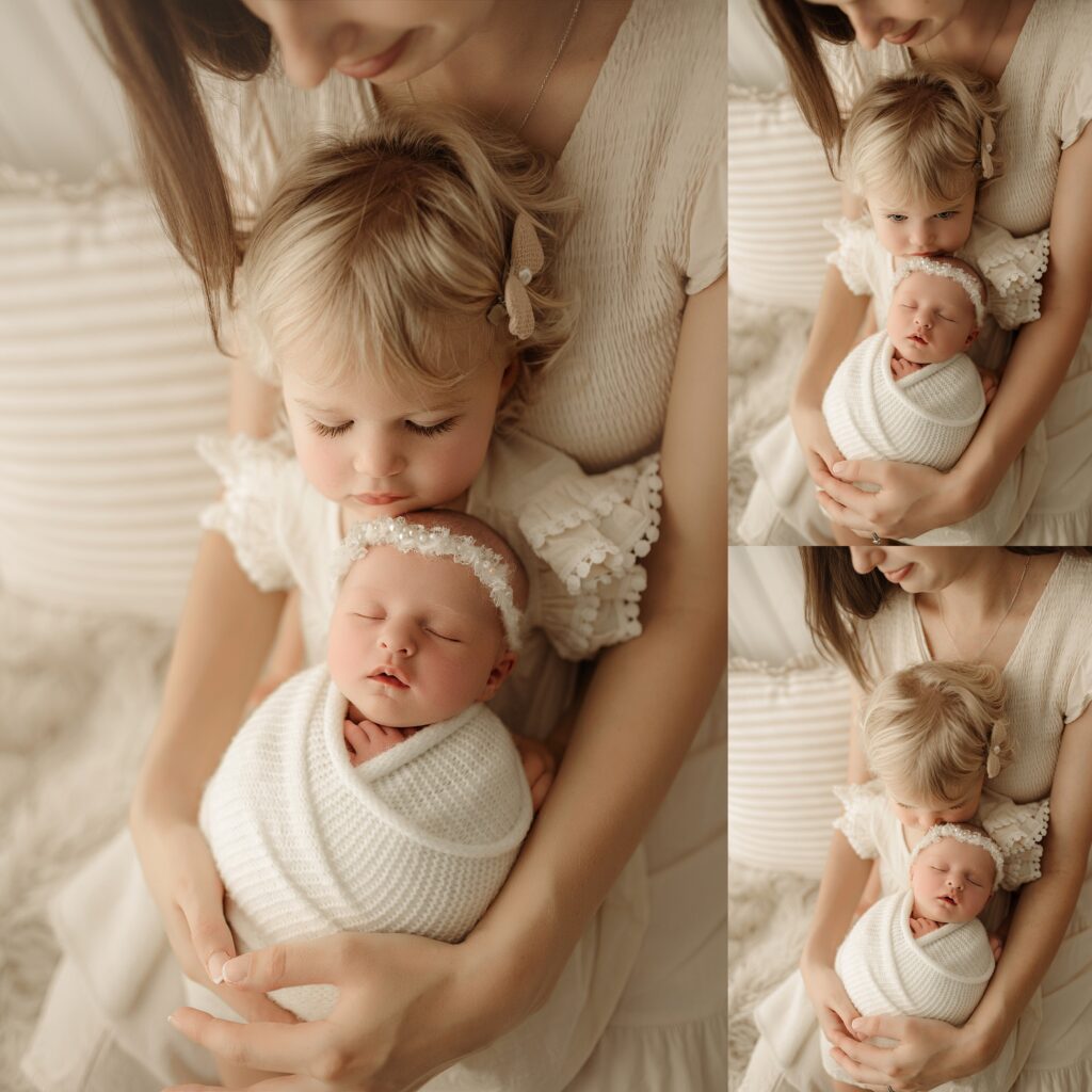 Older sibling gently holding a newborn baby during a newborn photography session