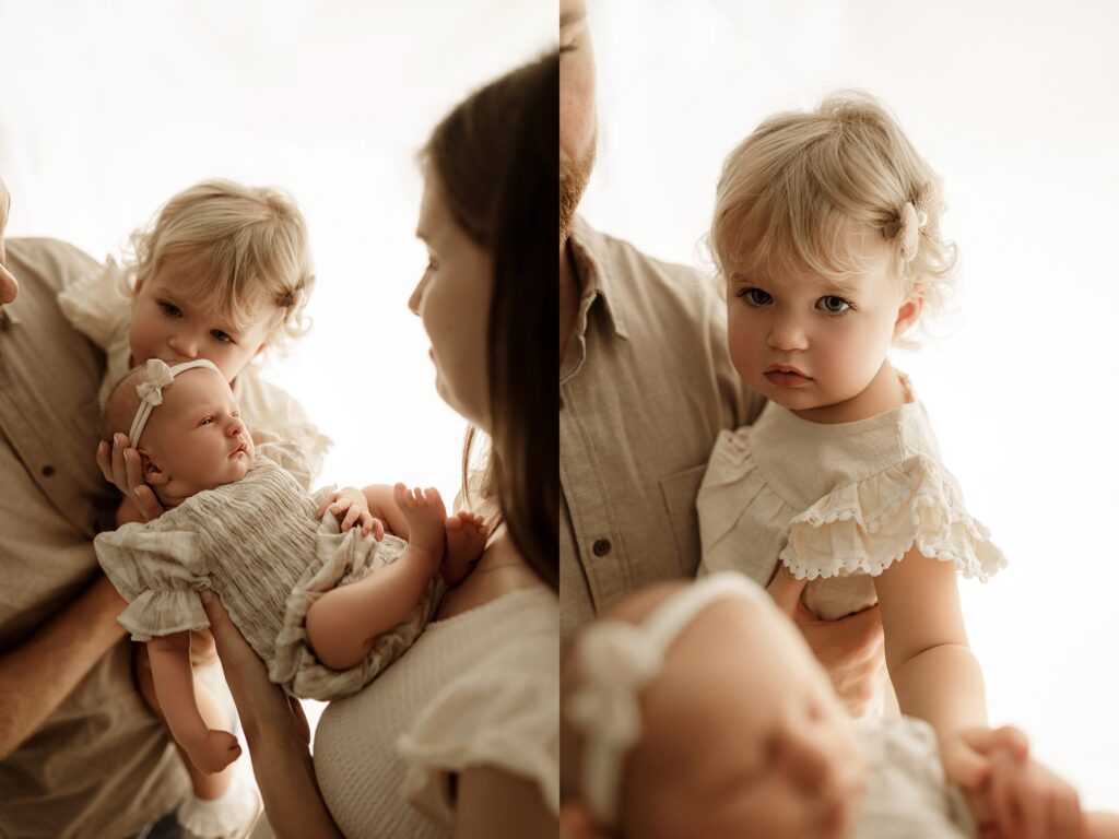 Parents cuddling their newborn baby during a professional newborn photography session