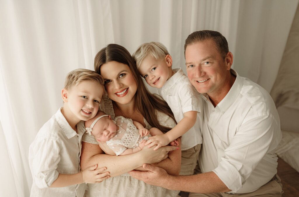 Parents holding their newborn baby during a family newborn photography session near Jacksonville Florida.