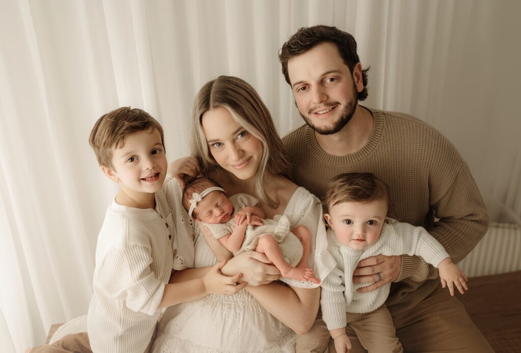 Parents holding their newborn baby during a family newborn photography session near Jacksonville Florida.